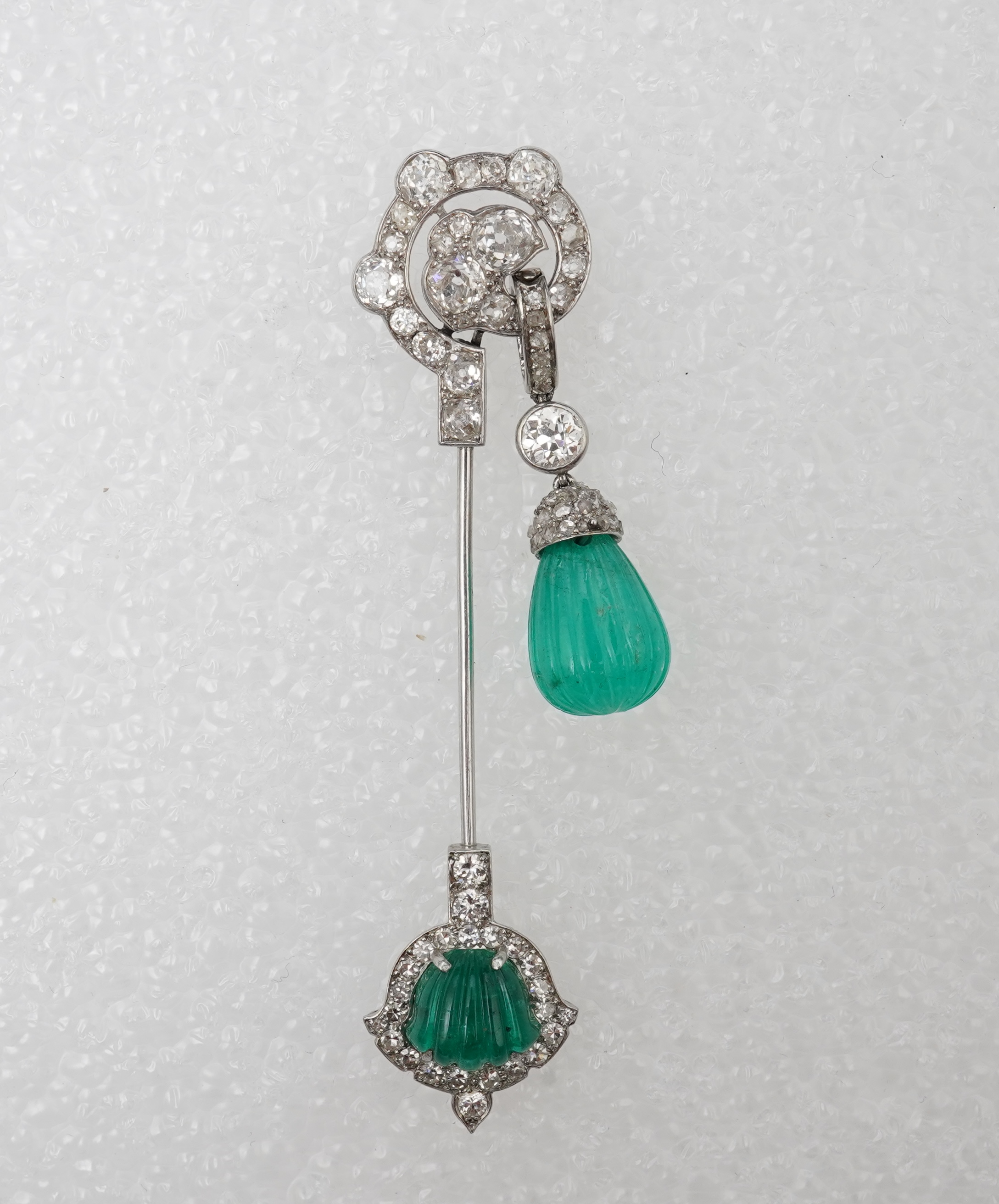 A fine Art Deco carved emerald and diamond jabot pin, circa 1925